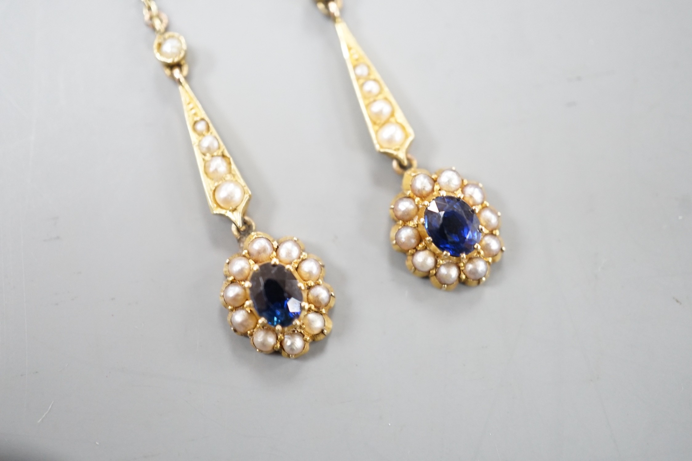A pair of yellow metal, sapphire and seed pearl set drop earrings. 41mm, gross weight 3.4 grams.